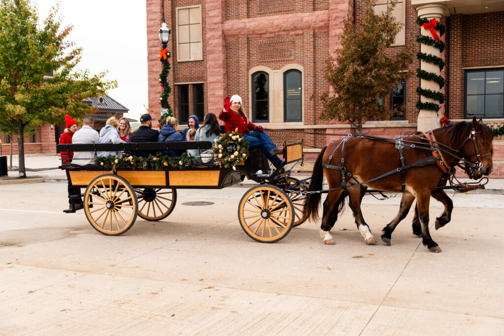 People riding in a cart pulled by horse