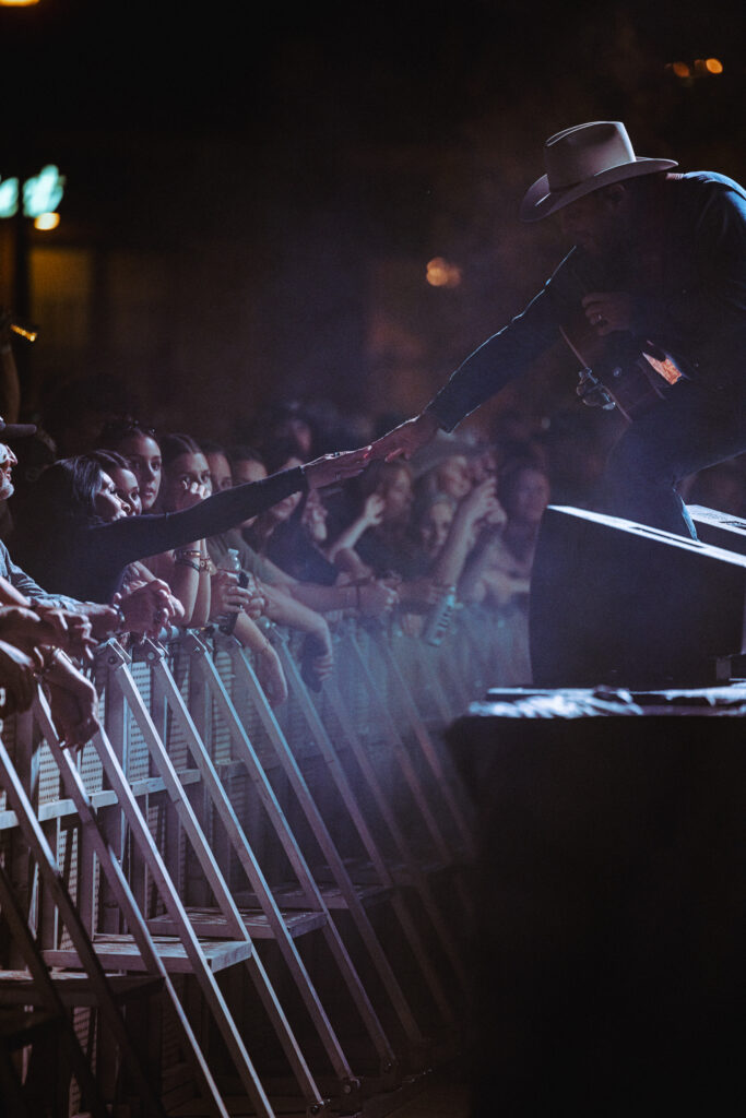 Singer reaching to people