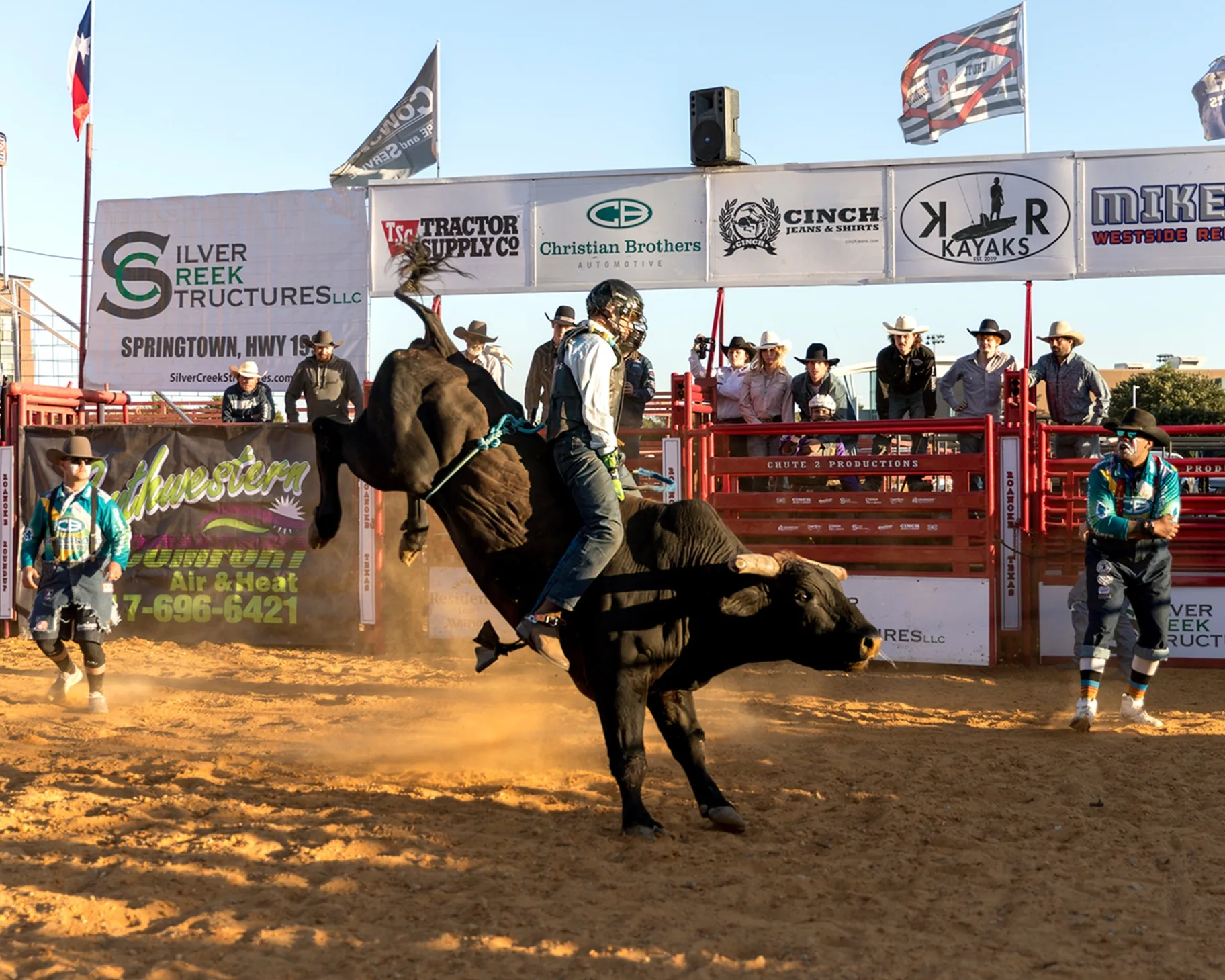 A man rides a bucking bull as it kicks out its hind legs