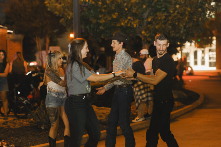 A group of couples is dancing in unison