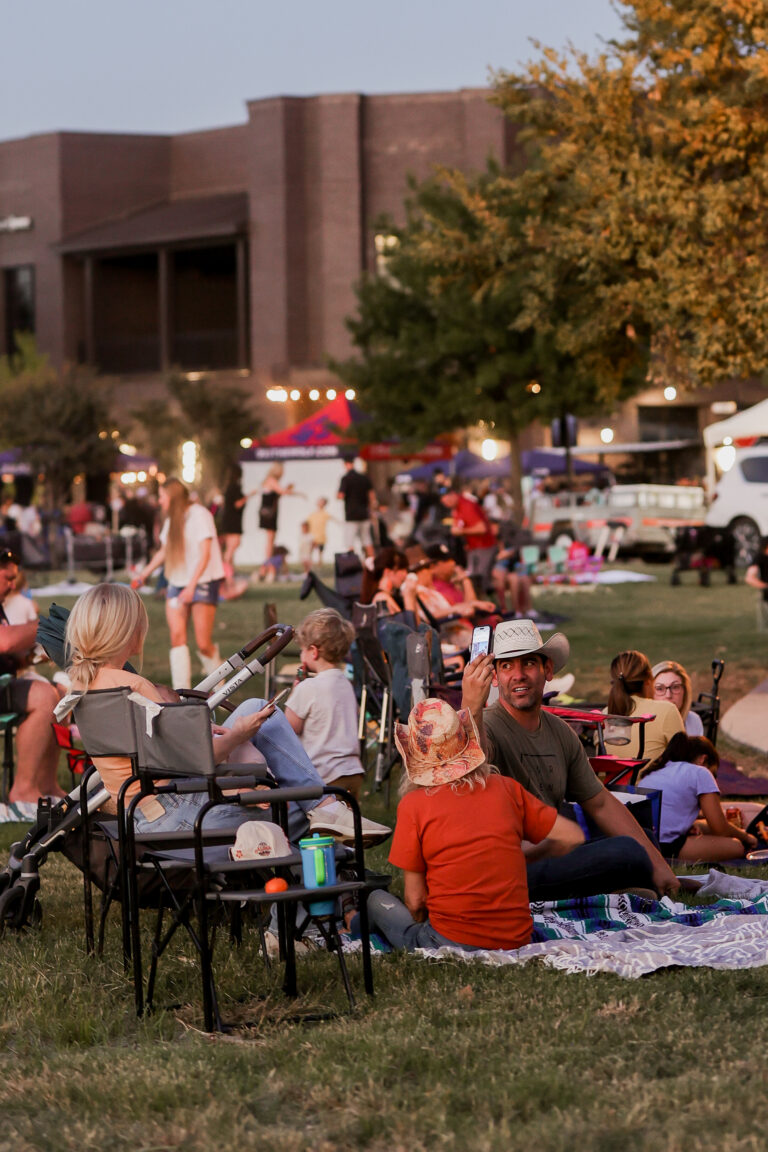 Families are sitting on the grass